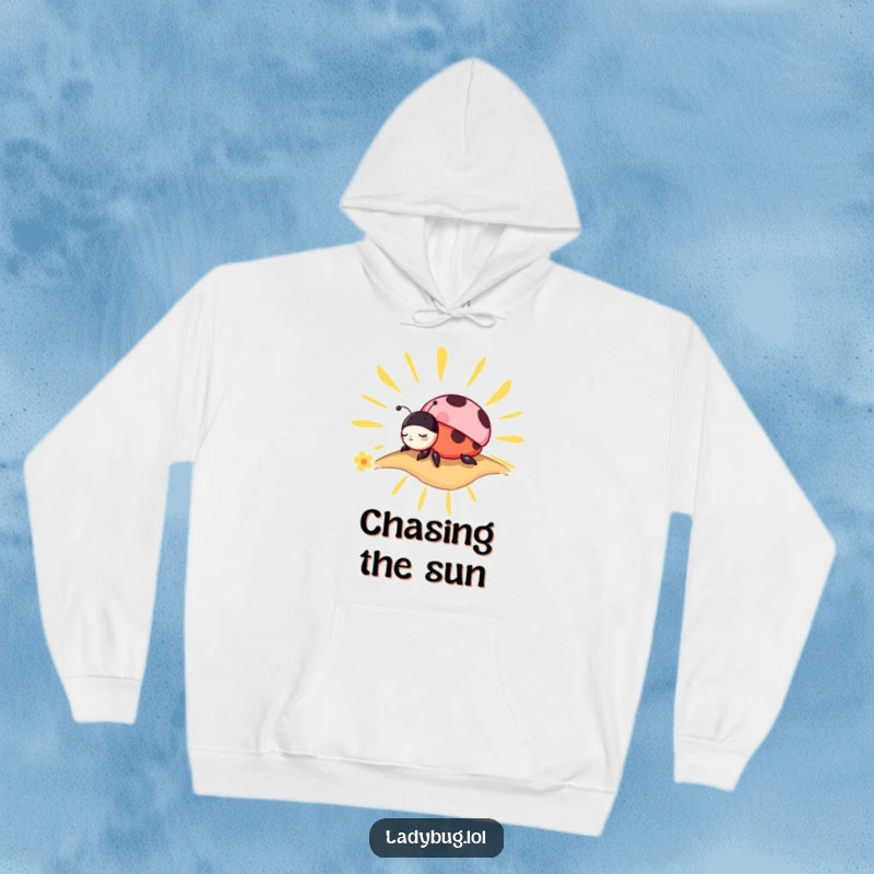 Funny Hoodie: Soft garment featuring a charming ladybug peacefully napping on a stylized sunbeam, ideal for cozy days.