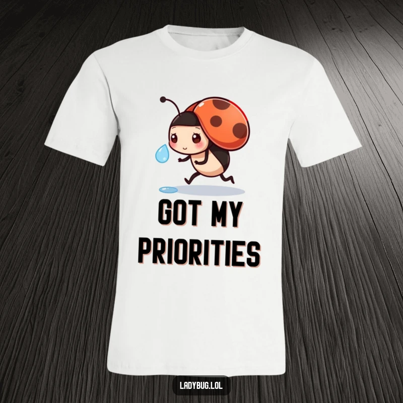 Funny t-shirt featuring a focused ladybug transporting a dewdrop, highlighting diligence and charming effort.